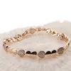 Bratara din cupru placat cu aur roz 18k cu elemente din zirconiu, model inimi duble, imagine 2