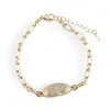 Bratara din cupru placat cu aur galben 18k cu element central oval si zirconii
