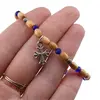 Bratara pe elastic cu lemn natural, margele albastre si charm cruce stilizata, imagine 3