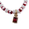 Bratara pe elastic cu margele albe, rosii si charm sticla de parfum, imagine 2
