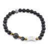 Bratara Agat negru sfere 6mm, Larvikit 8mm si luna din Sidef 12mm cu bumbi aurii
