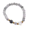 Bratara Cuart gri sfere 6mm, Larvikit 8mm si steluta din Sidef 10mm cu bumbi aurii