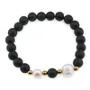 Bratara pe elastic Perle de cultura, bumbi aurii si Onix sfere mate 8mm