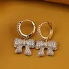 Cercei din cupru placat cu aur galben 18k, model fundita cu zirconii, imagine 2