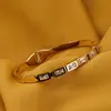 Bratara cupru placat cu aur galben 18k cu zirconii dreptunghiulare baguette, imagine 2