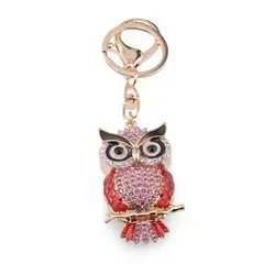 Breloc auriu bufnita emailata cu pene rosii, cristale roz si ochi protectori, 12cm