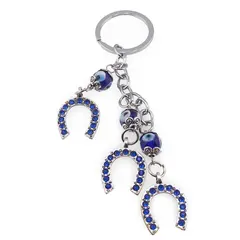 Breloc Feng Shui cu trei potcoave si ochi protectori